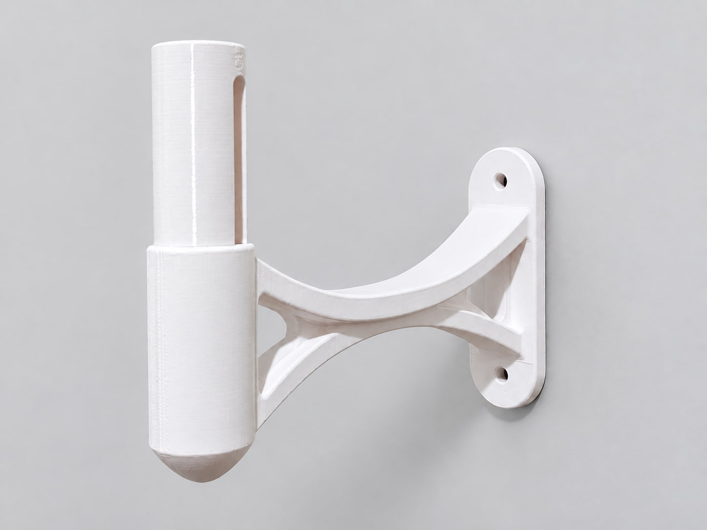 White curved-arm wall bracket with an upright slotted peg